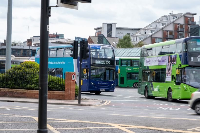 Image with local buses on the street